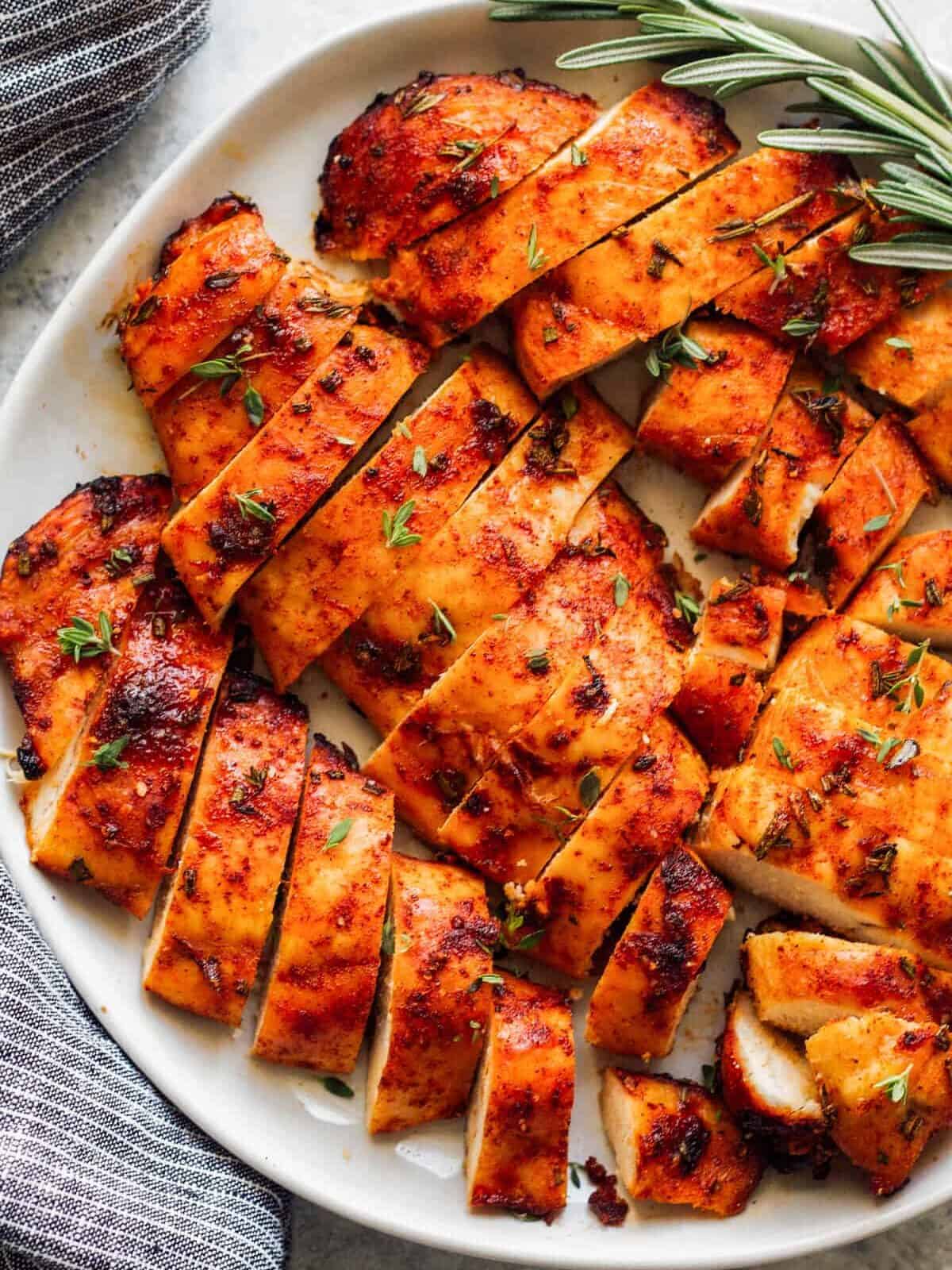 sliced baked chicken breast on large plate