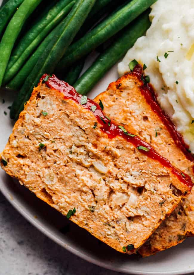 chicken meatloaf on plate with green beans and mashed potatoes