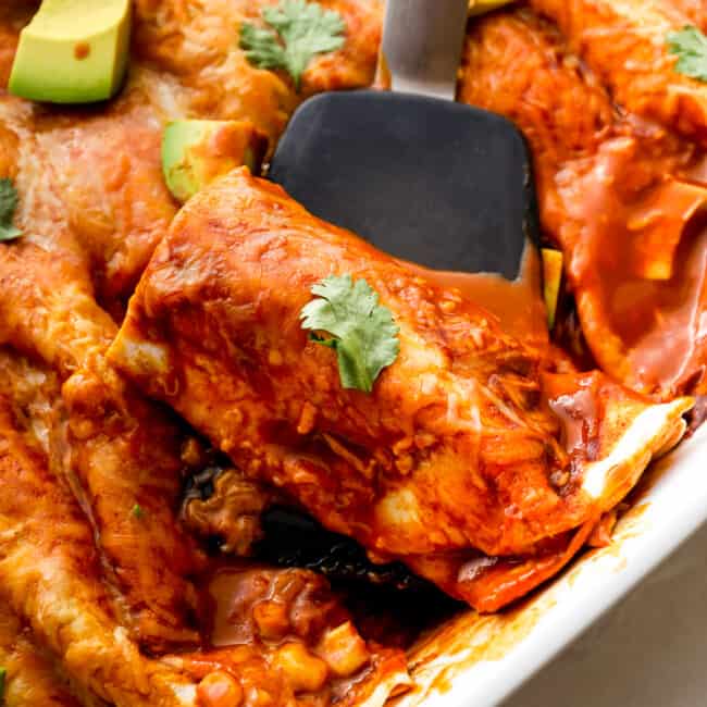 lifting up red chicken enchilada