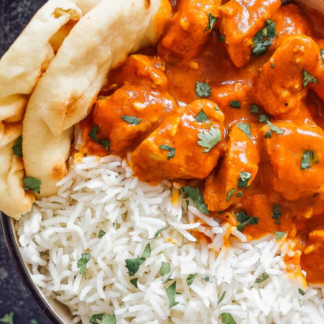 up close image of bowl of chicken tikka masala with rice